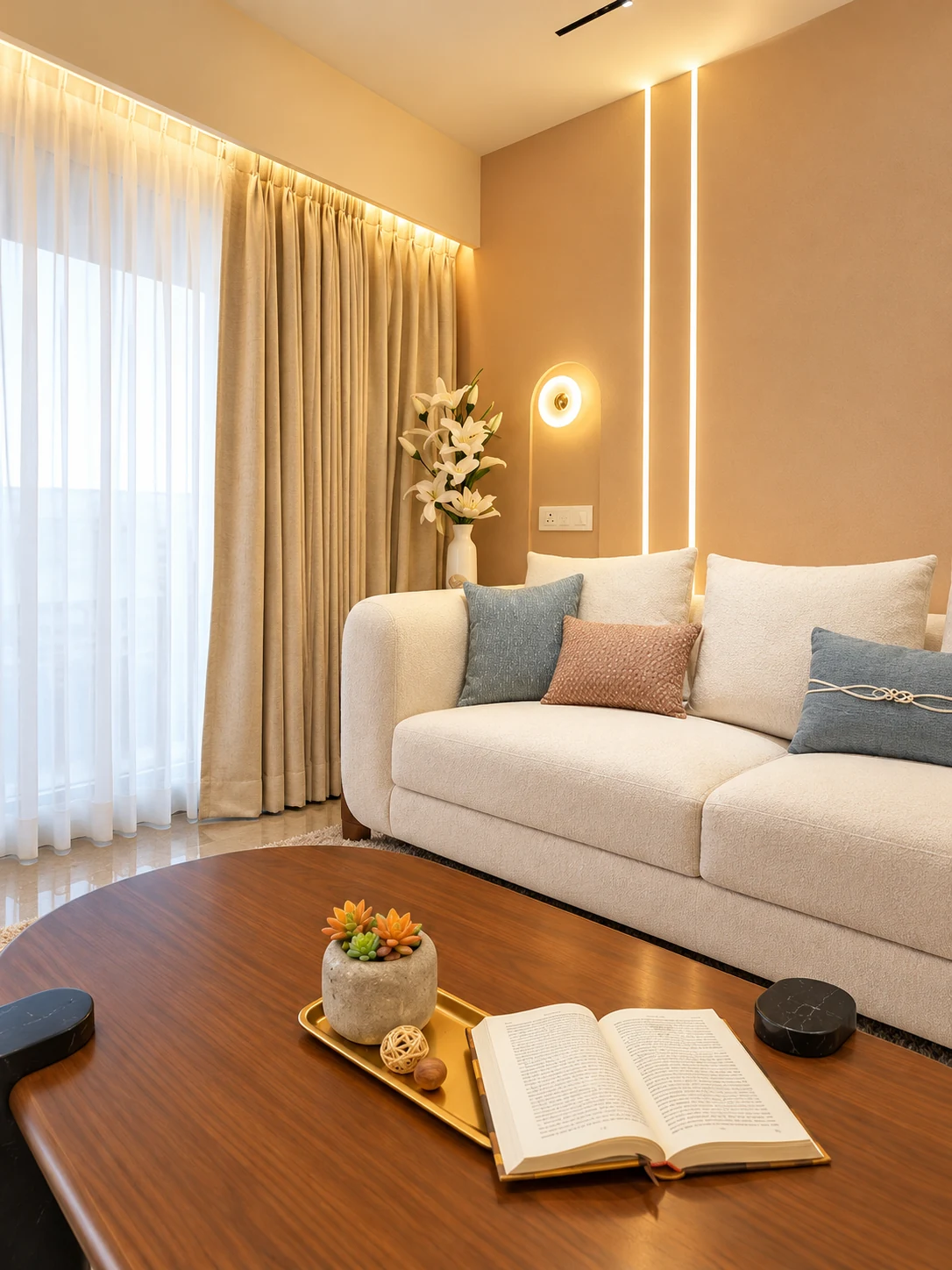 Sofa beside full-height curtains, blue cushions and a wood-toned coffee table.